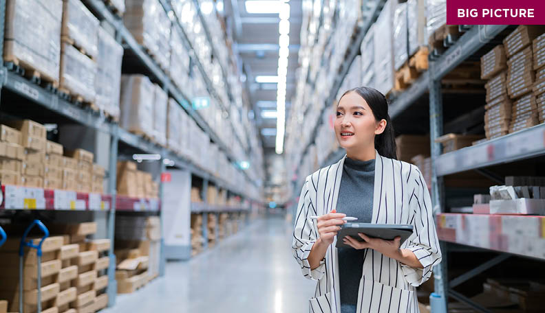 Woman business owner using digital tablet checking amount of stock